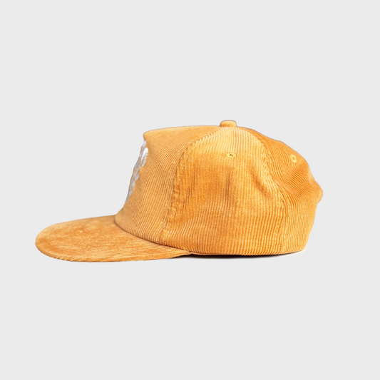 Yellow corduroy cap on a light gray background